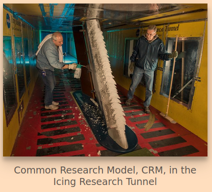 Common Research Model, CRM, in the Icing Research Tunnel. 
Two researchers observe glaze "lobster tail" ice on the leading edge of a test airfoil.